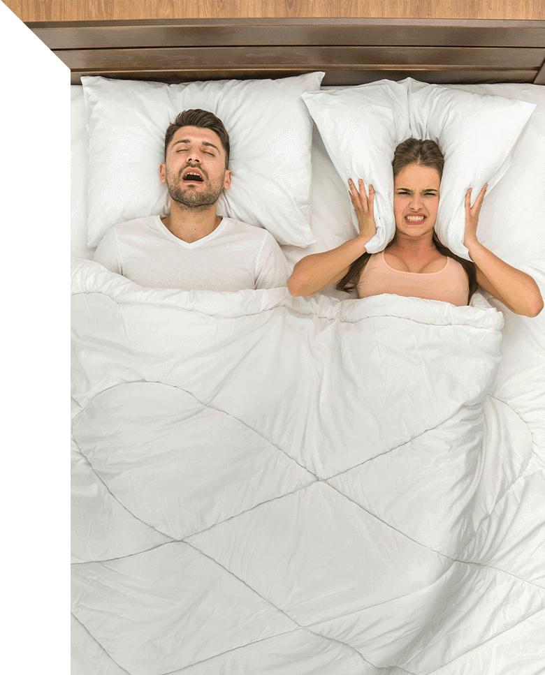 couple sleeping with woman frustrated at man snoring